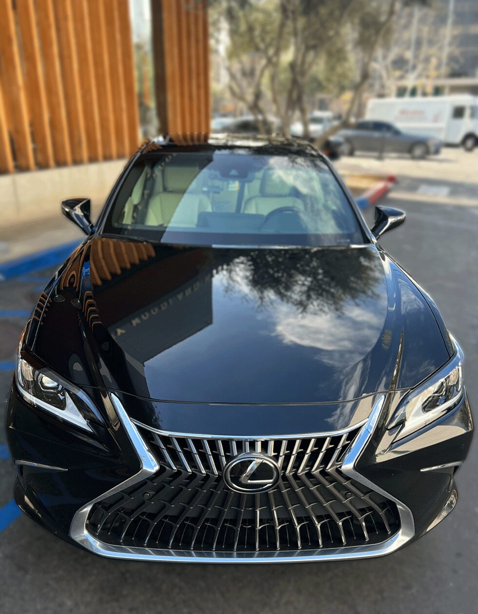 Front view of a black Lexus ES with mirror-like reflections after professional ceramic coating in Los Angeles